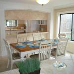 Bright and sunny dining room with ocean views from bay windows